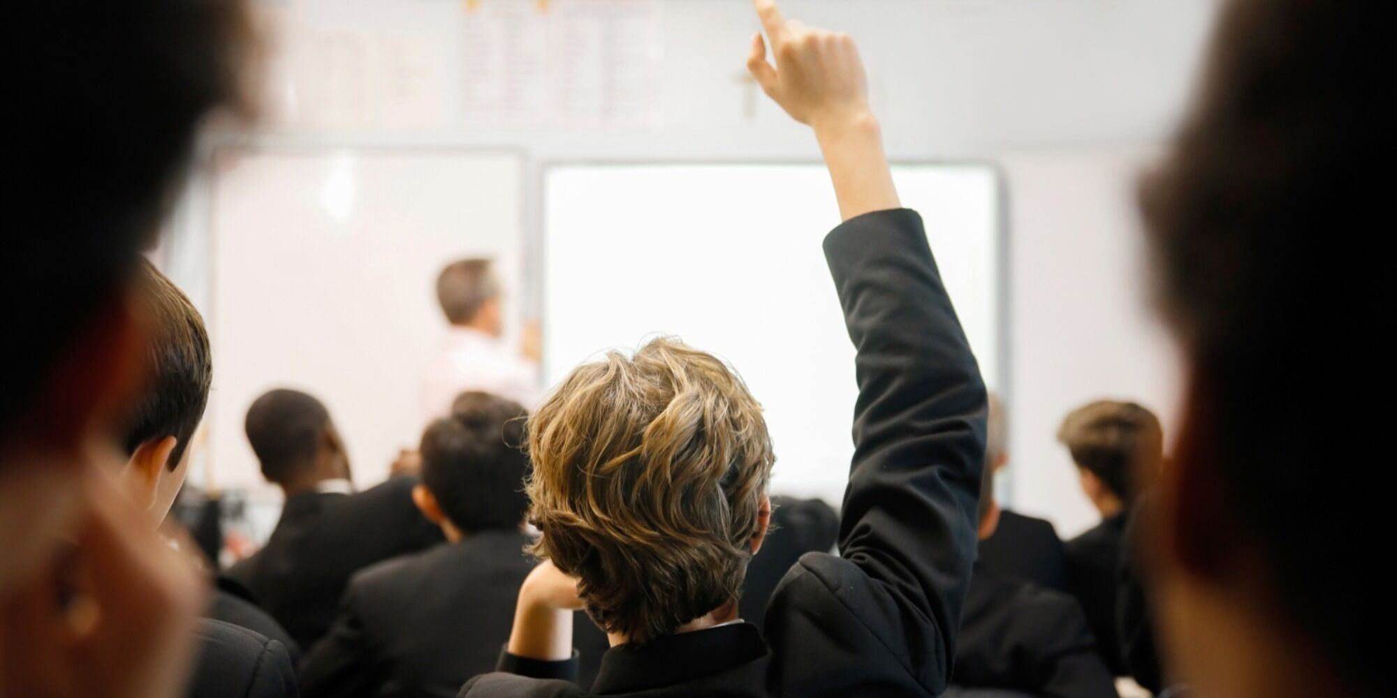 Student with hand up, ready to answer a question